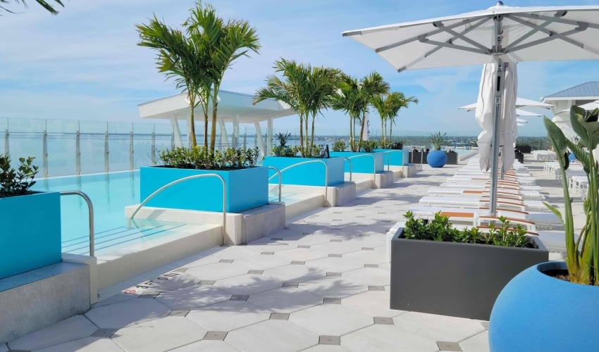 Rows of poolside sunbeds at Level Blue Rooftop Pool & Bar at Sunseeker Resort