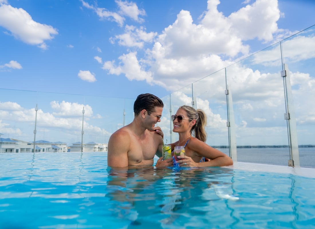 couple in pool with drinks