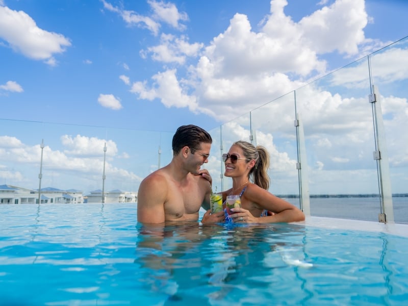 couple in pool with drinks