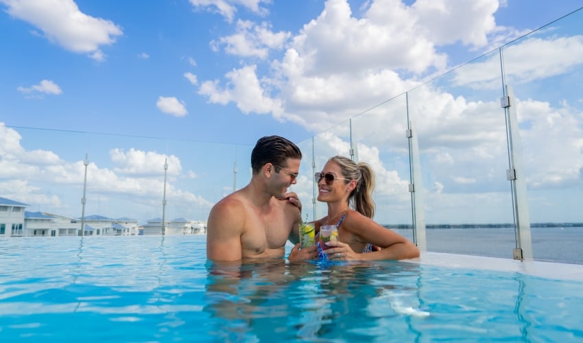 couple in pool with drinks