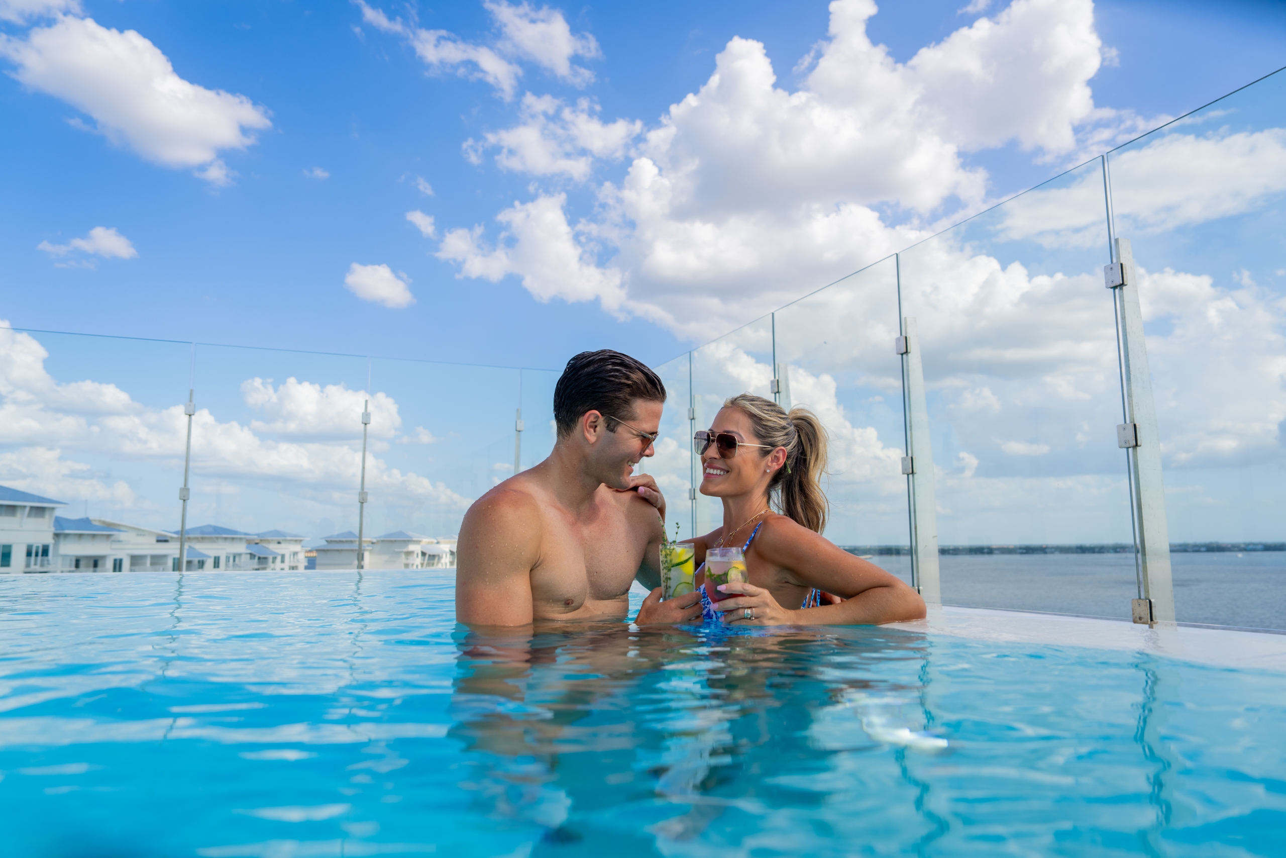couple in pool with drinks
