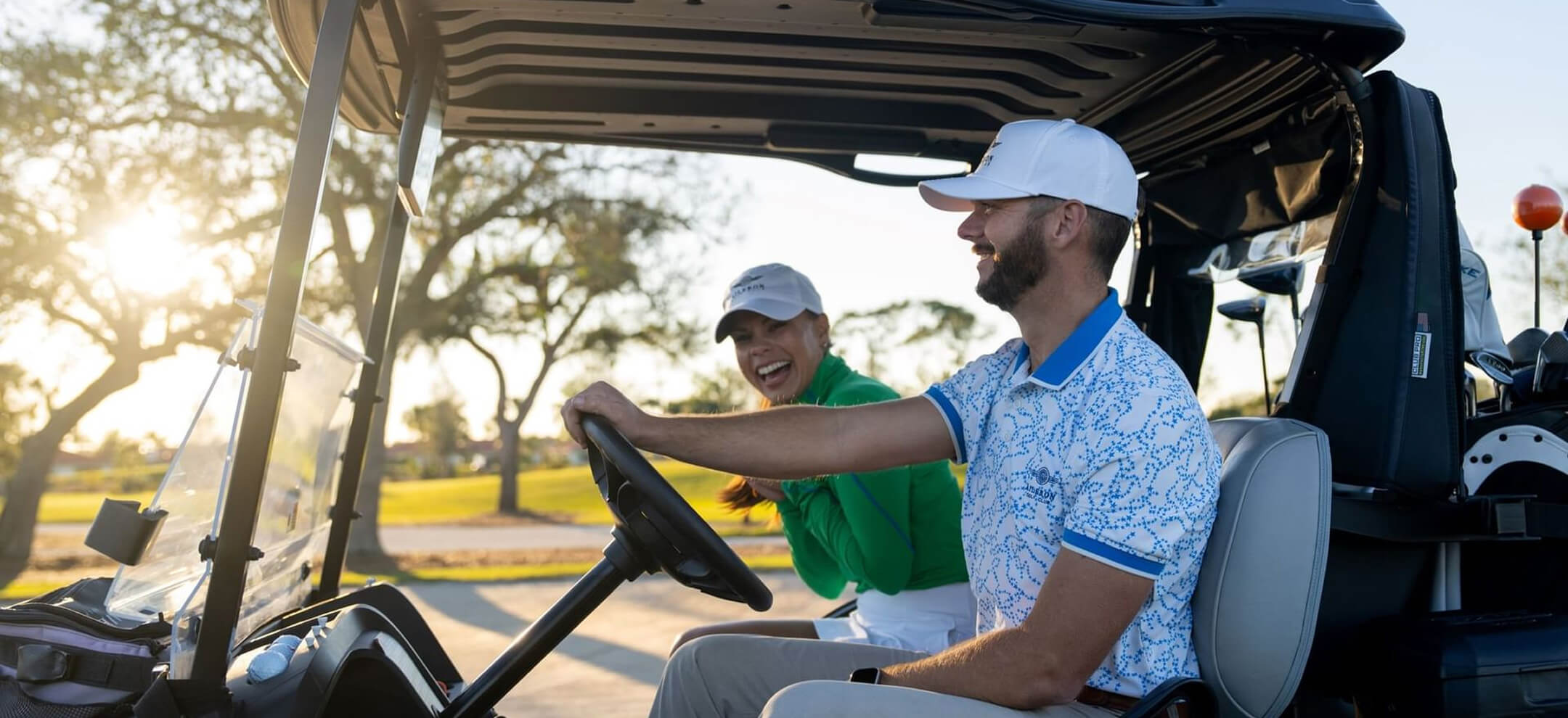 Golfers on a golf cart at Aileron golf club
