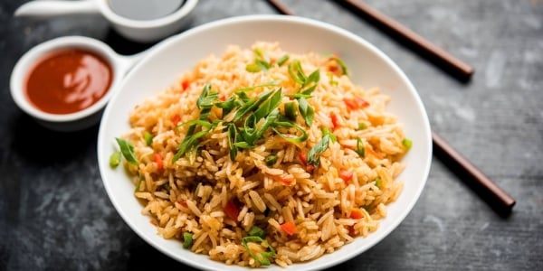 Rice dish served with sauce and chopsticks at Daikon- Asian Kitchen