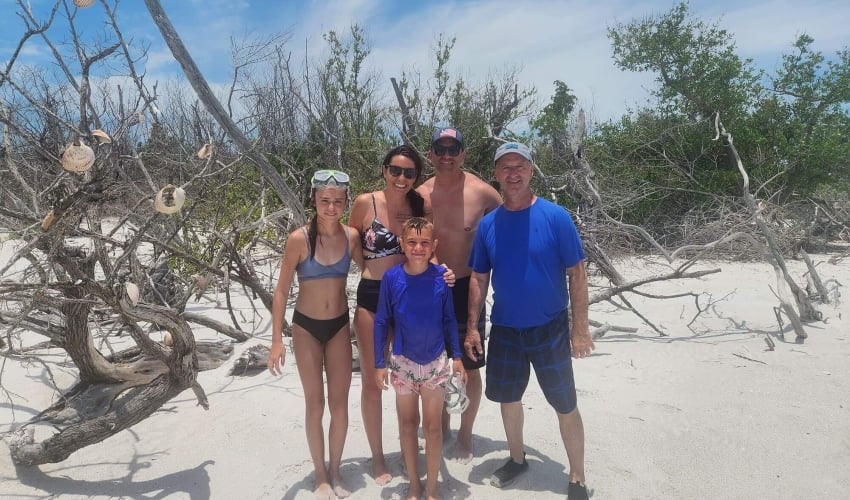 family on a white sand beach