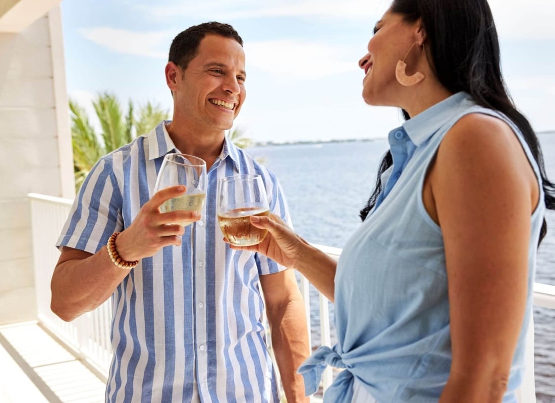 Couple smiling and clinking glasses at Sunseeker Resort