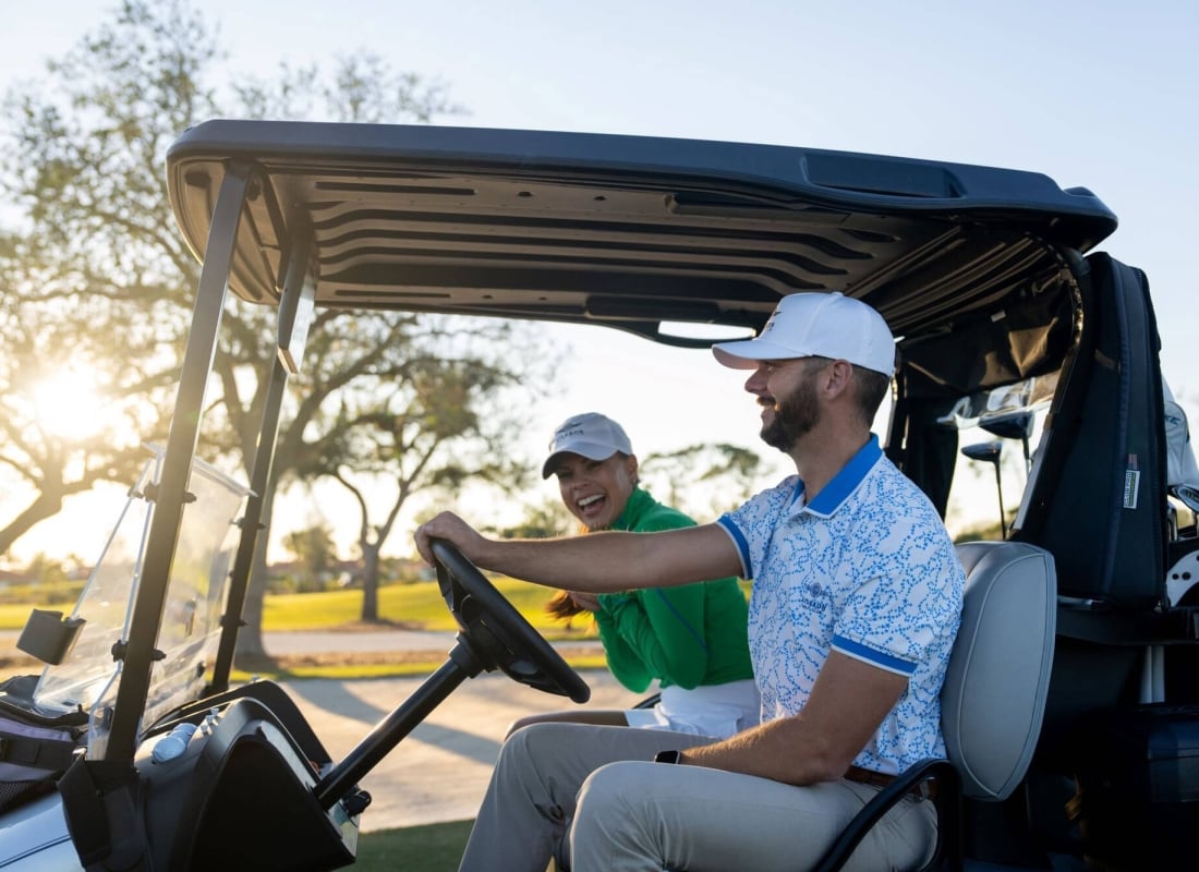 Golfers on a golf cart at Aileron golf club
