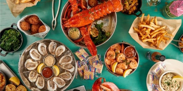 Eclectic specialties including Bucket O’ Shrimp, Steamed Clams, and Baked Oysters, as well as notable favorites like Fresh Grilled Fish, fries and lobster.