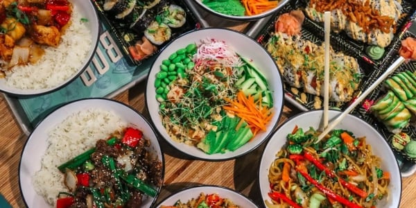 Assortment of asian food such as sushi, poke bowls, noodles and more served at Daikon - Asian Kitchen