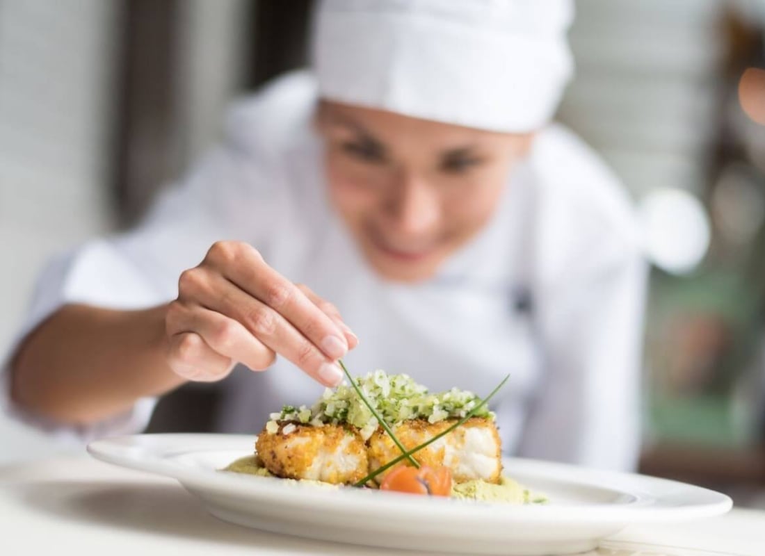 Chef garnishing her food