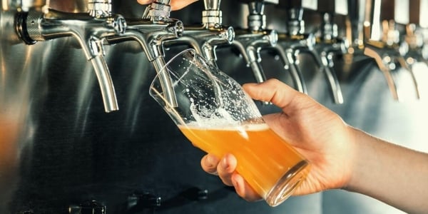 Man pouring beer from tap