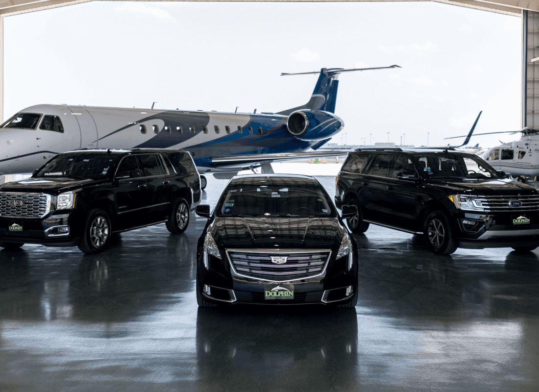 Private jet and luxury SUVs in an air hanger