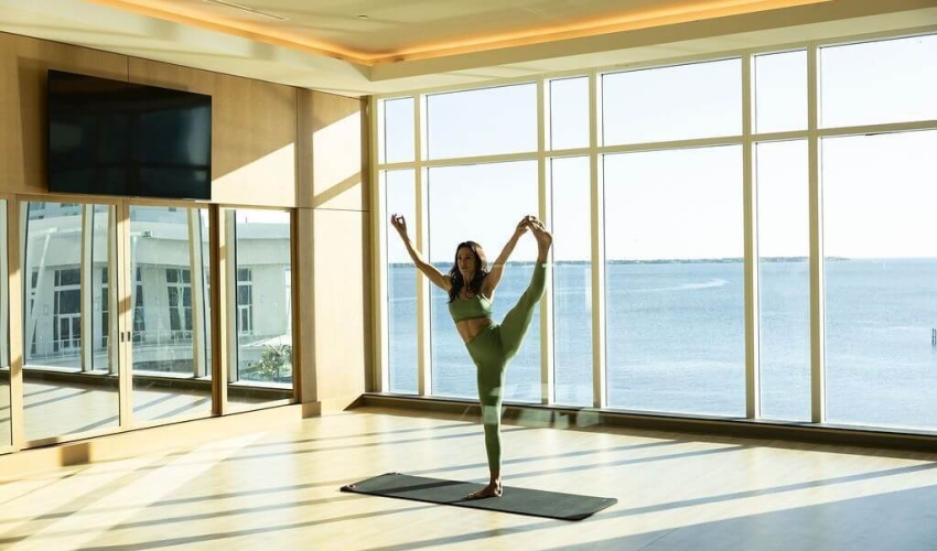 Woman doing yoga in the fitness center at Sunseeker Resort