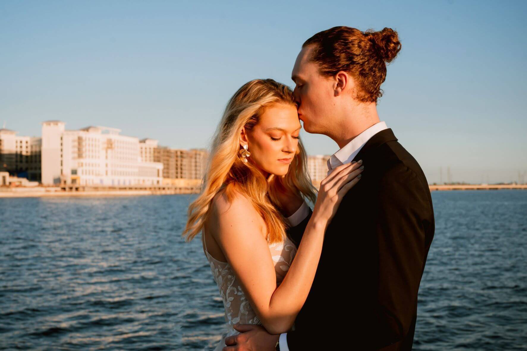Couple taking wedding pictures with Charlotte Harbor and Sunseeker Resort