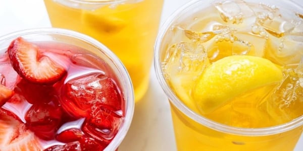Yellow and red juices in plastic cups