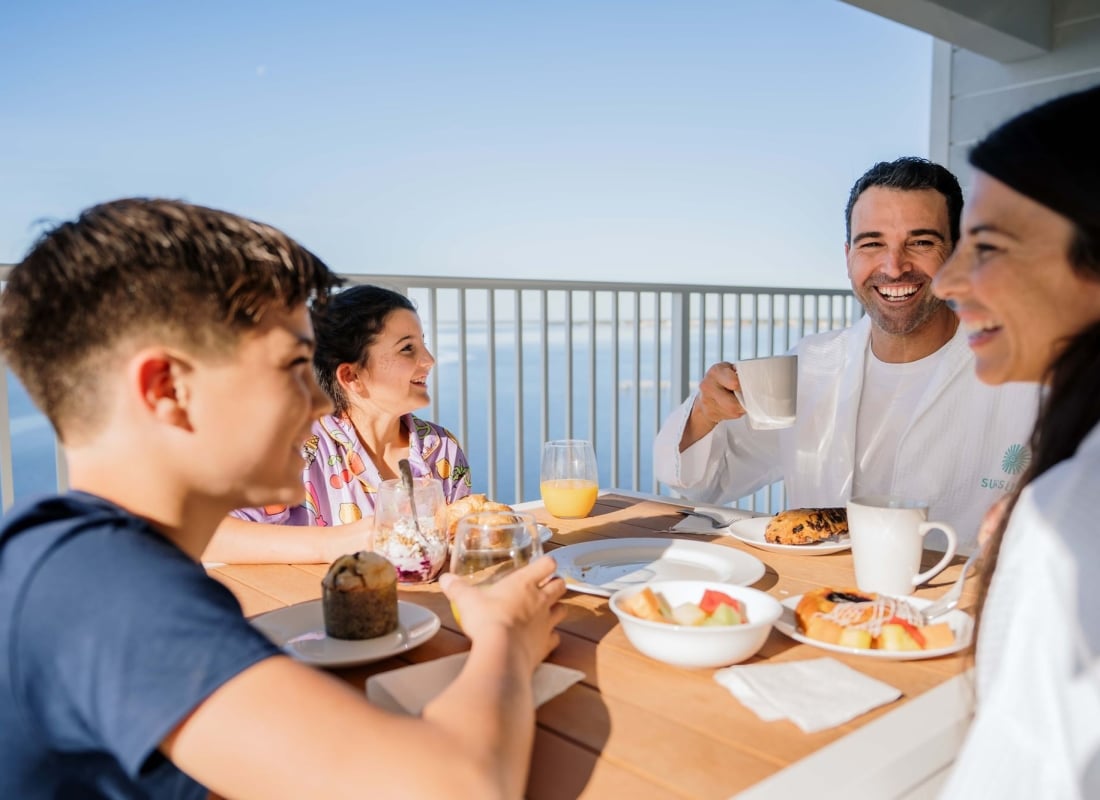 Family having breakfast on resort balcony at Sunseeker Resort