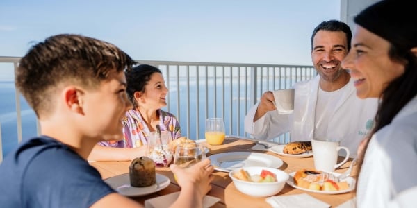 Family having breakfast on resort balcony at Sunseeker Resort