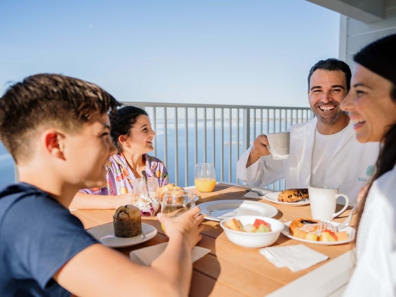 Family having breakfast on resort balcony at Sunseeker Resort