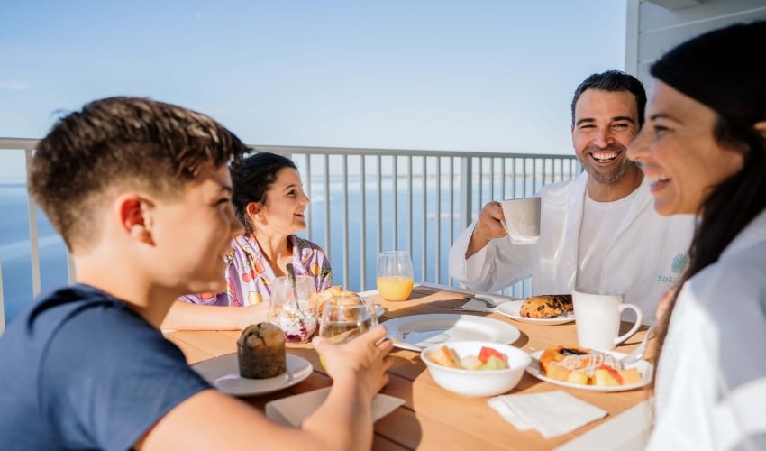 Family having breakfast on resort balcony at Sunseeker Resort