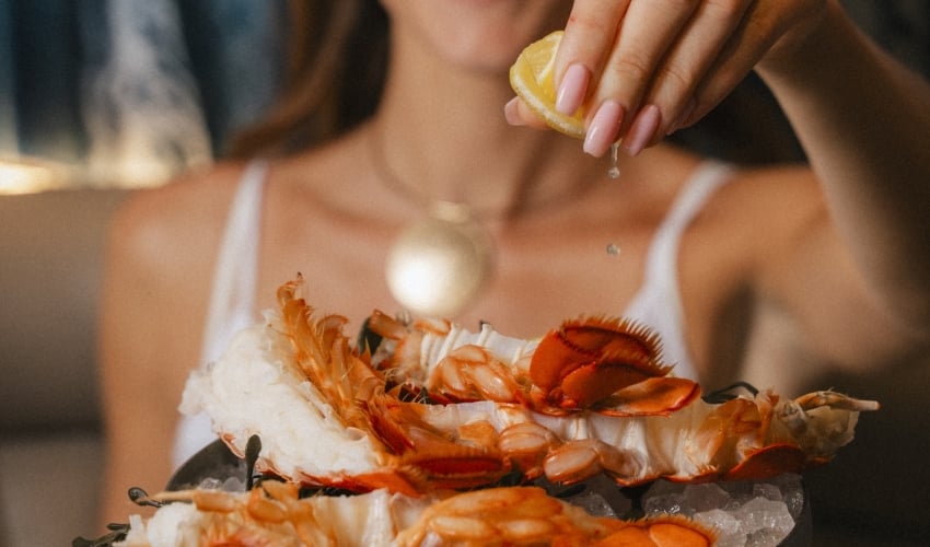 Squeezing lemon on seafood