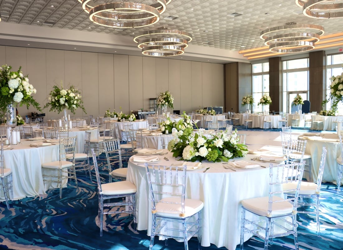 Elegant wedding reception setup with dance floor in the Great Egret Ballroom at Sunseeker Resort, overlooking Charlotte Harbor, Florida.