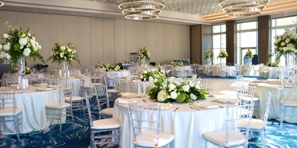 Elegant wedding reception setup with dance floor in the Great Egret Ballroom at Sunseeker Resort, overlooking Charlotte Harbor, Florida.