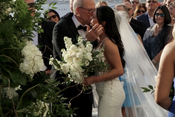 Bride celebrating Florida Gulf Coast wedding with family on the lawn