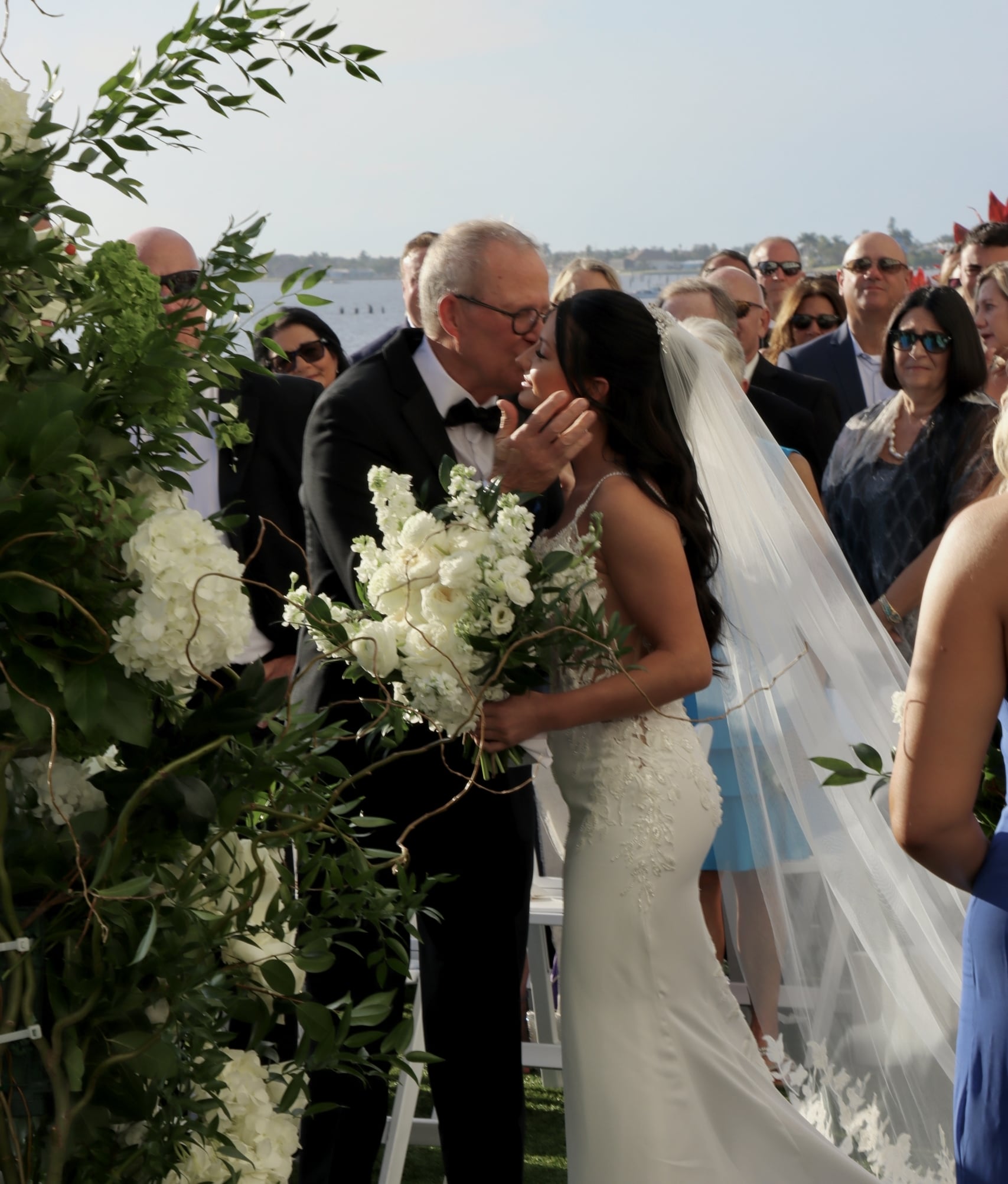Bride celebrating Florida Gulf Coast wedding with family on the lawn